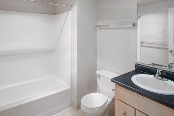 Bathroom with standing shower tubat Collins Circle Apartments in Portland OR